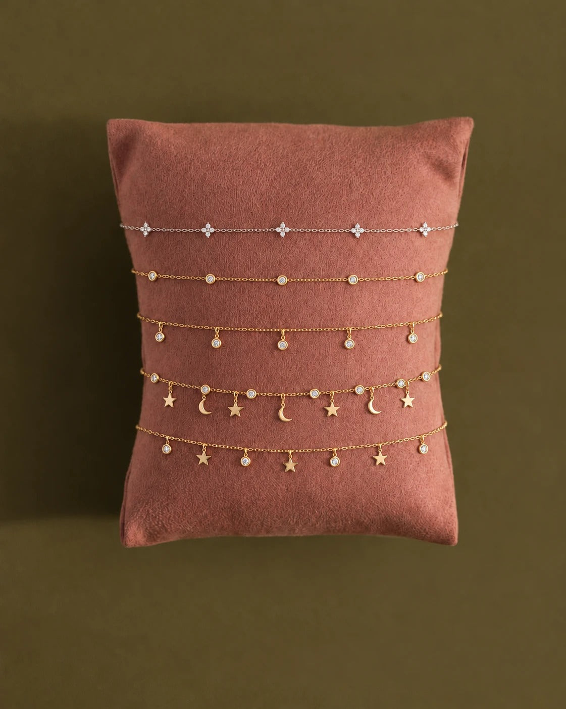 Most Loved bracelets and necklaces on a pillow